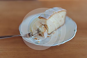 Eating a delicate lemon drizzle cake slice