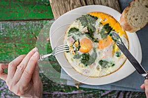 Eating Florentine eggs with purred spinach horizontal