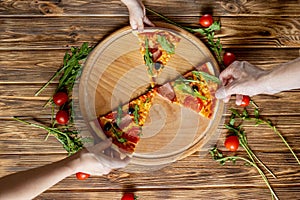 Eating Food. Close-up Of People Hands Taking Slices Of Pepperoni Pizza. Group Of Friends Sharing Pizza Together. Fast Food,