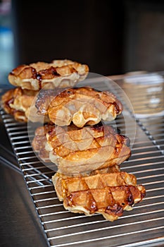 Eating of fresh baked hot Belgian sugar waffles, street food in Bruges