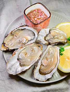 Eating of fresh big raw Zeeuwse Creuse Dutch oysters from Zeeland, Netherlands