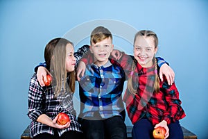 Eating fruits and vegetables benefits childrens health. Cute little children holding red apples. Apple is a health food