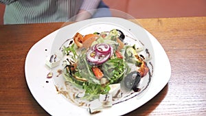 Eating a Greek salad close-up