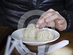 Eating with hands poses - traditional Buryat food photo