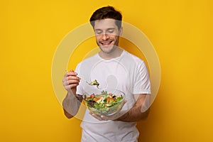 Portrait of Smiling Guy Holding Bowl With Salad