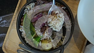 Eating medium rare wagyu beef steak over rice fusion Asian twist food