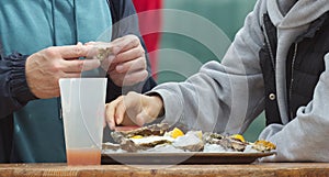 Eating oysters at a street food market.