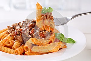 Eating Penne Rigate Bolognese or Bolognaise sauce noodles pasta