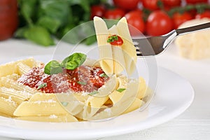 Eating Penne Rigate Napoli with tomato sauce noodles pasta meal photo
