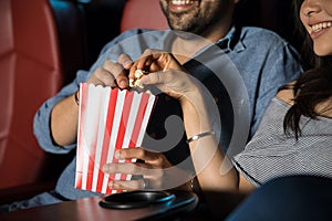 Eating popcorn at the movie theater