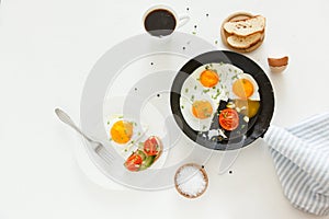 Eating in the process, fried eggs in a frying pan and on a plate, toast with avocado and a cup of coffee for breakfast.