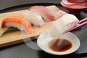 Eating Sea Bream Sushi with Chopsticks and Sake, Japanese Food photo