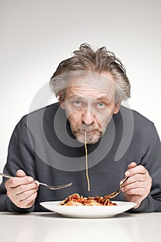 Eating spaghetti with minced pork and beef meat, tomato sauce and cheese