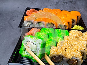 Eating sushi with chopsticks, selective focus