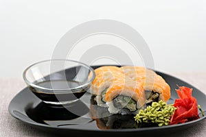 Eating Sushi with chopsticks. Sushi roll japanese food in restaurant. California Sushi roll set with salmon, vegetables