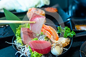 Eating Sushi with chopsticks. Sushi roll japanese food in restaurant. with salmon, vegetables, flying fish roe and caviar closeup.