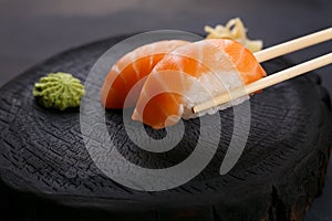 Eating sushi. Delicious Japanese cuisine, nigiri sushi with salm