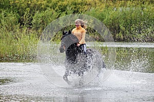 Beauty equestrian model ride a horse through a summer foresth