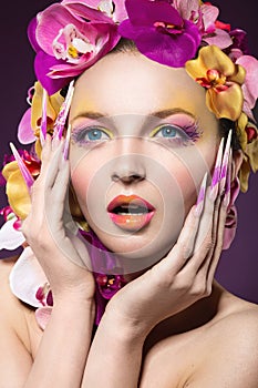 Eautiful woman with hair made of flowers and long nails