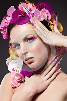 Eautiful woman with hair made of flowers and long nails