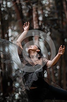 eautiful women with black ballet costumes flying in the air like reaching something in the sky