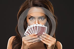 Eauty woman is hiding under playing cards,