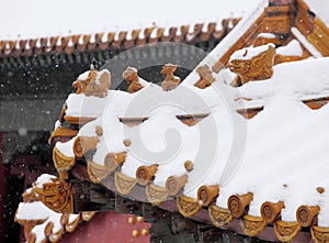 The eaves of ancient buildings in the Forbidden City covered with snow..