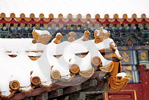 The eaves of ancient buildings in the Forbidden City covered with snow. .
