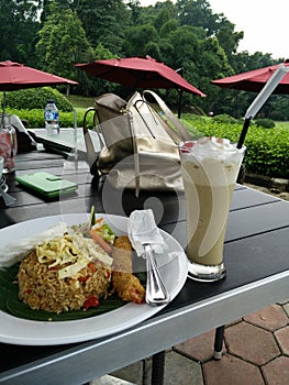 Ebi furai fried rice and cappuccino with whipped cream in Kebun raya Bogor photo