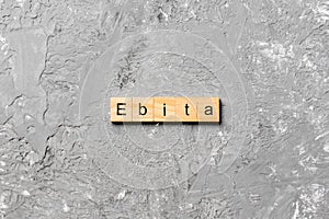 EBITA word written on wood block. EBITA text on cement table for your desing, concept