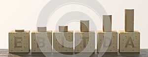 EBITDA word built with letter cubes on white background and stacked coins. 3d illustration