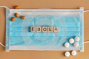 Ebola is laid out with wooden cubes on a surgical face mask.