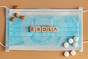 Ebola is laid out with wooden cubes on a surgical face mask. photo