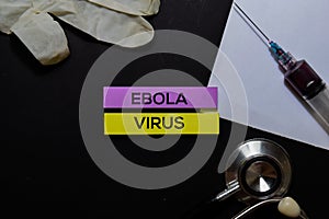 Ebola Virus text on Sticky Notes. Top view isolated on office desk. Healthcare/Medical concept