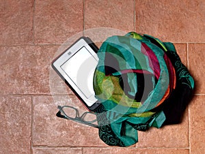 Ebook reader with eyeglasses and scarf