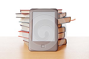 Ebook reader vs pile of books photo