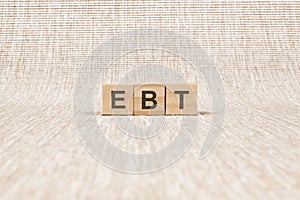 EBT word written on wood blocks. text on brown backgrond for your desing, concept