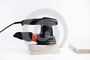 Eccentric grinding machine. Power tool. On a white background. Bars of wood