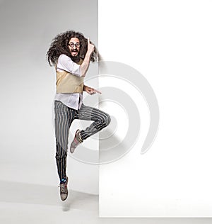 Eccentric man pointng on the empty board