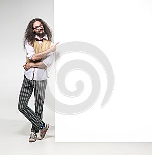 Eccentric man pointng on the empty board