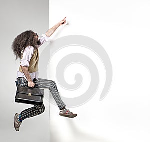 Eccentric man pointng on the empty board