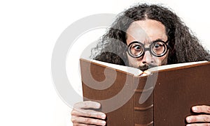 Eccentric, young nerd reading a book