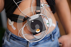 Ecg holter monitor hanging on patient body closeup