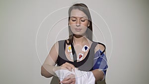 ECG sensors, electrocardiogram and blood pressure measurement. Woman with Holter