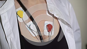 ECG sensors, electrocardiogram and blood pressure measurement. Woman with Holter