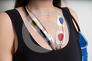 ECG sensors, electrocardiogram and blood pressure measurement. Woman with Holter