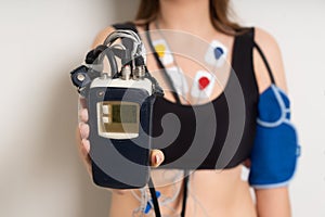 ECG sensors, electrocardiogram and blood pressure measurement. Woman with Holter