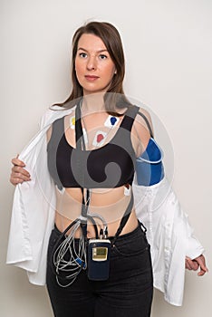 ECG sensors, electrocardiogram and blood pressure measurement. Woman with Holter