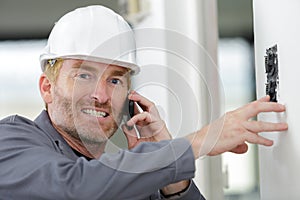 echanic using mobile phone in workshop