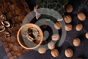 Echeveria plant and walnuts on blue slate table. Healthy nuts and seeds composition.